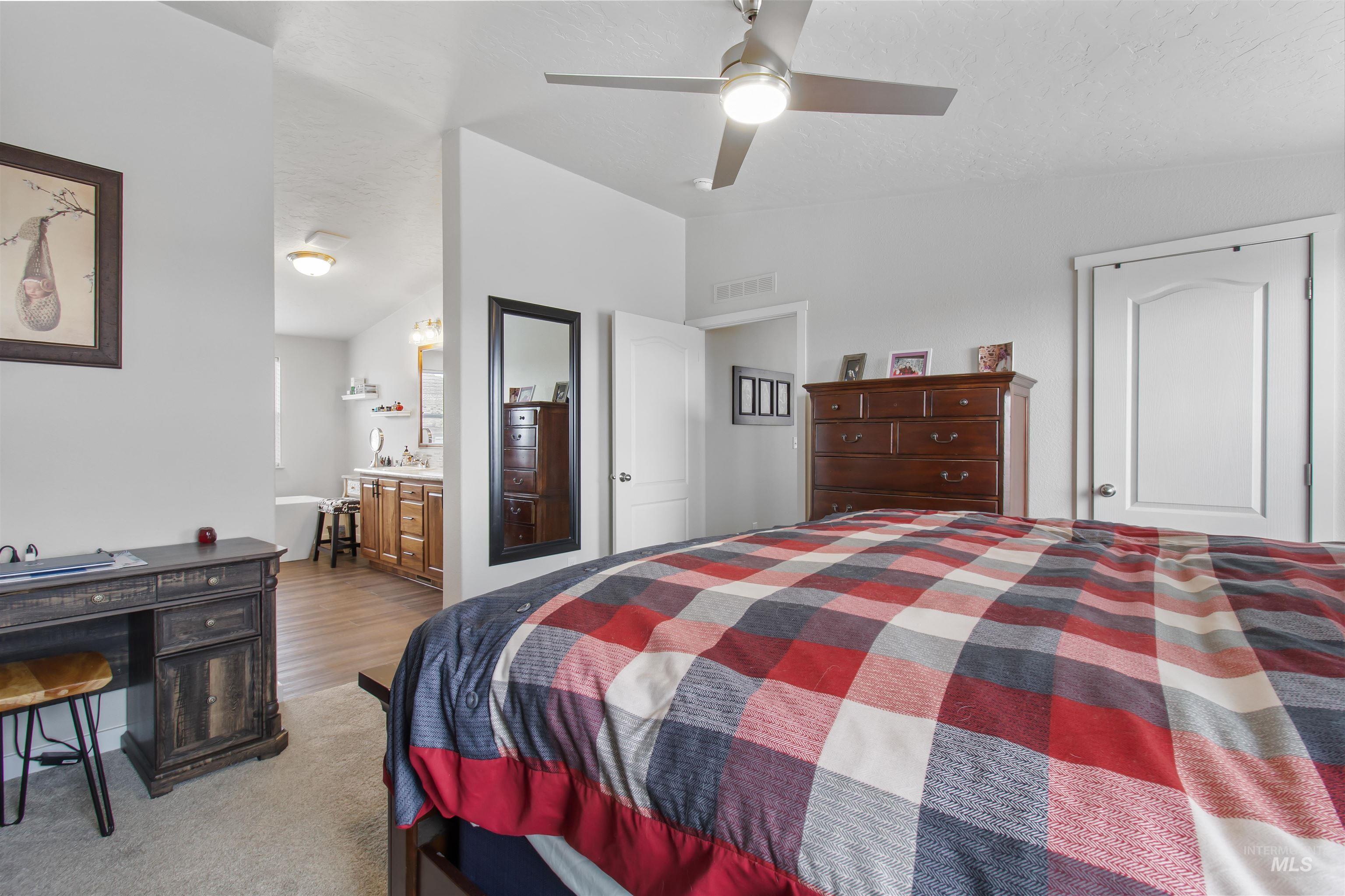161 Horseshoe Loop West Fairfield, ID 83327 - Photo 28 of 50 Bedroom featuring lofted ceiling, light carpet, ceiling fan, a closet, and connected bathroom
