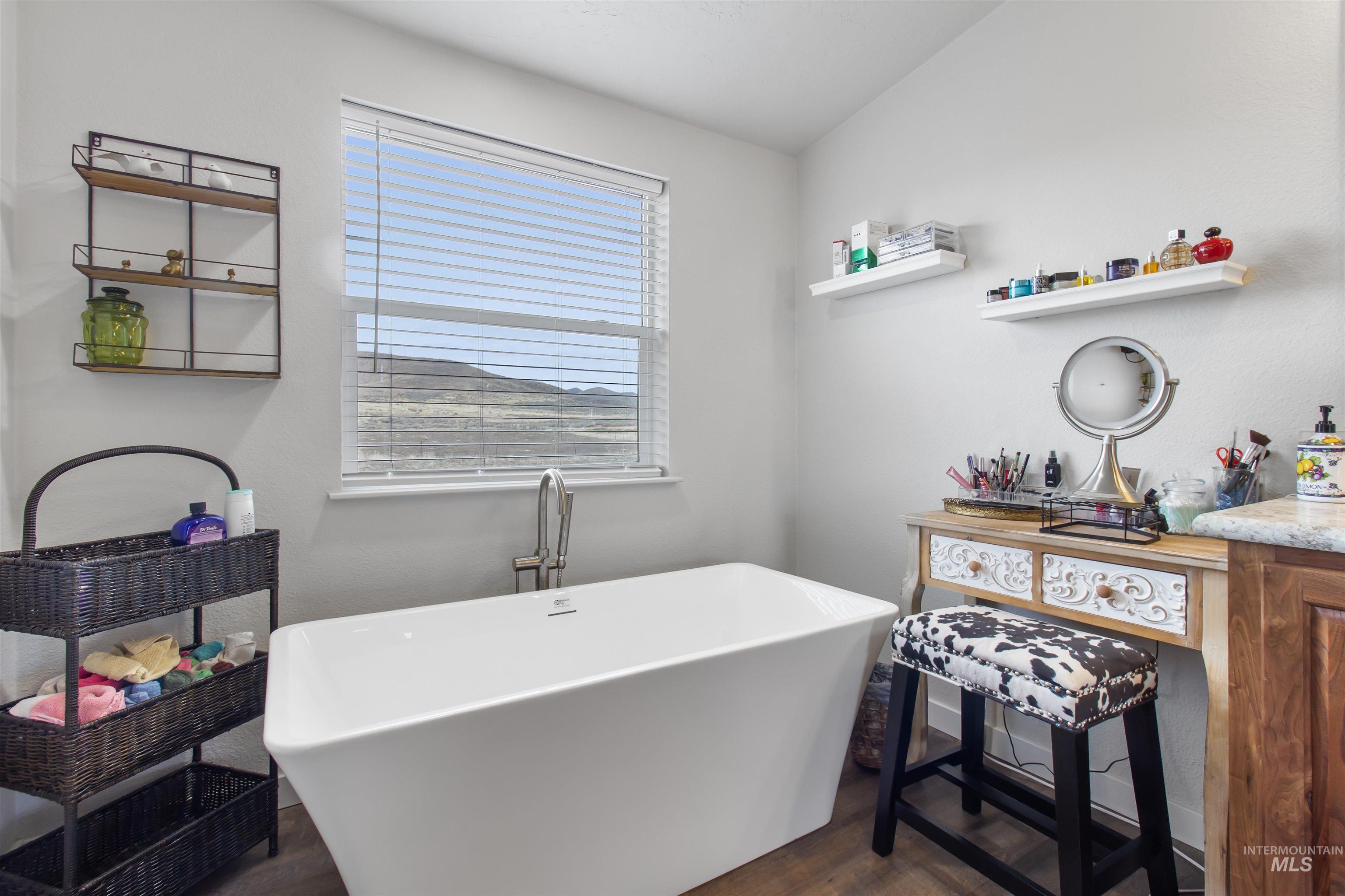 161 Horseshoe Loop West Fairfield, ID 83327 - Photo 33 of 50 Bathroom featuring vanity, dark wood finished floors, and a freestanding tub