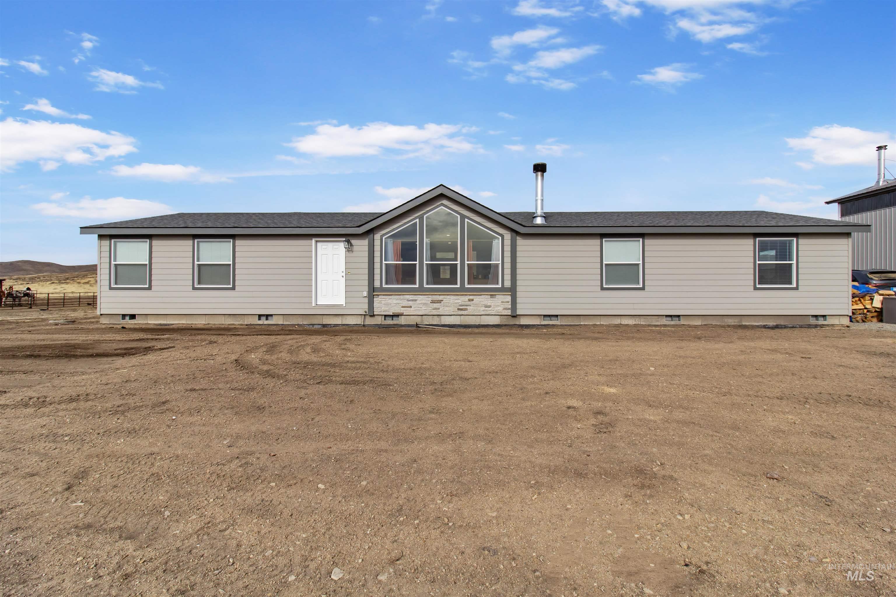 161 Horseshoe Loop West Fairfield, ID 83327 - Photo 8 of 50 Rear view of house featuring crawl space and roof with shingles