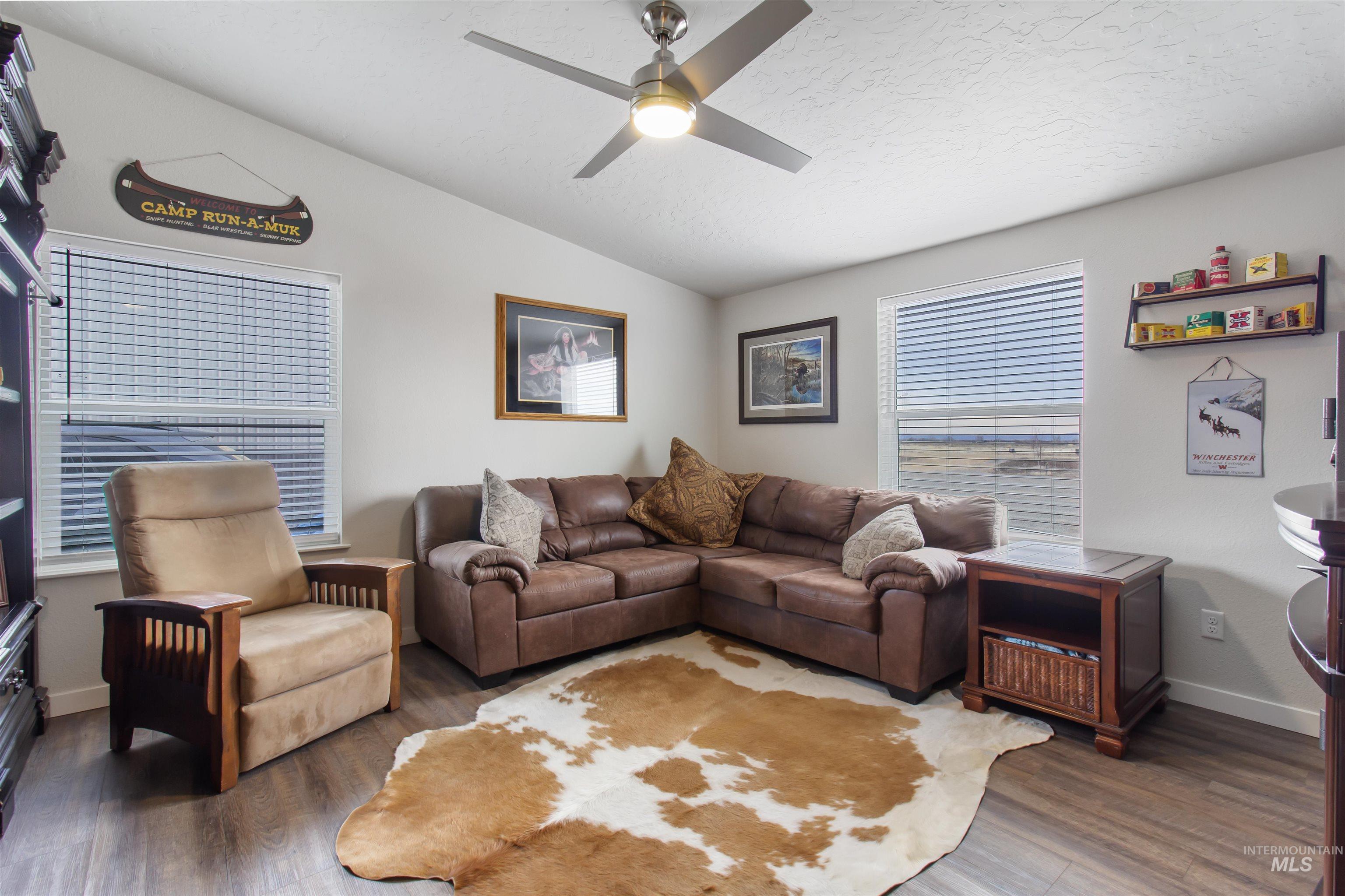 161 Horseshoe Loop West Fairfield, ID 83327 - Photo 9 of 50 Living area featuring lofted ceiling, ceiling fan, and wood finished floors
