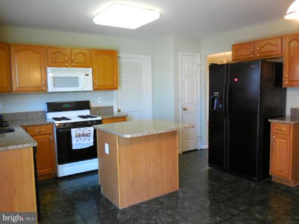 1751 Canal Run Drive Point of Rocks, MD 21777 - Photo 4 of 23 a kitchen with stainless steel appliances granite countertop a stove a refrigerator and a stove