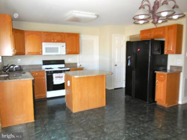 1751 Canal Run Drive Point of Rocks, MD 21777 - Photo 5 of 23 a kitchen with stainless steel appliances granite countertop a stove refrigerator and dishwasher with wooden floor