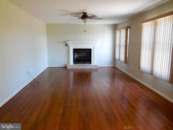 1751 Canal Run Drive Point of Rocks, MD 21777 - Photo 8 of 23 an empty room with wooden floor a ceiling fan and windows