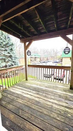 a view of a wooden deck next to a yard