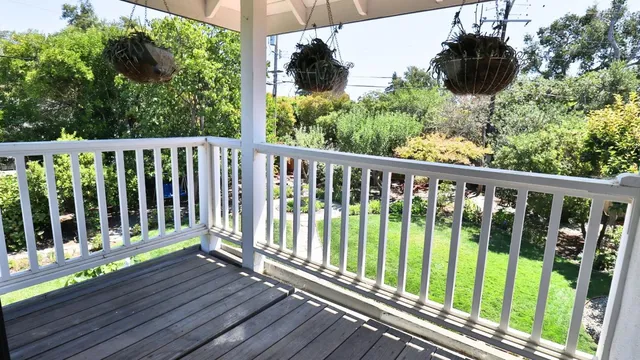 a view of a balcony with wooden floor