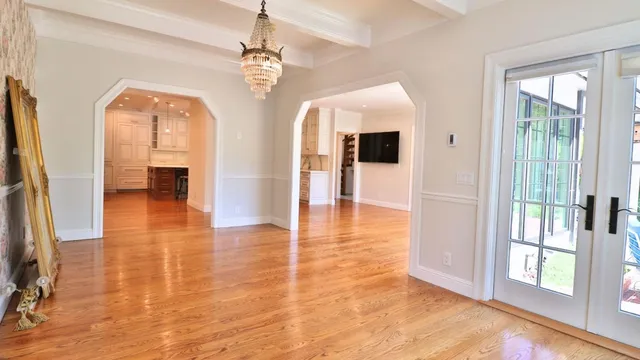 an empty room with wooden floor and a window