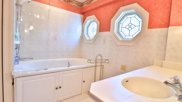a bathroom with a bathtub and a sink
