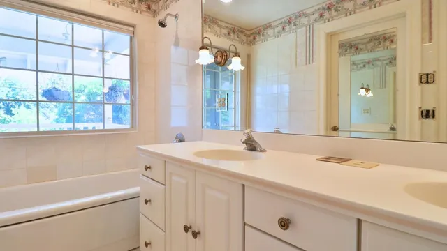 a view of a patio with table and chairs under an umbrella