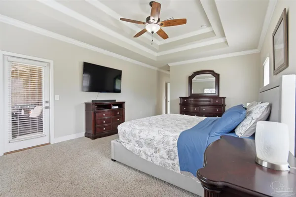a bed room with a bed a television and dresser
