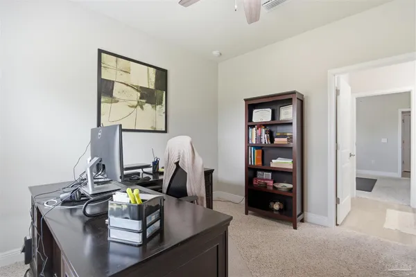 a view of workspace with lounge chair and cabinet