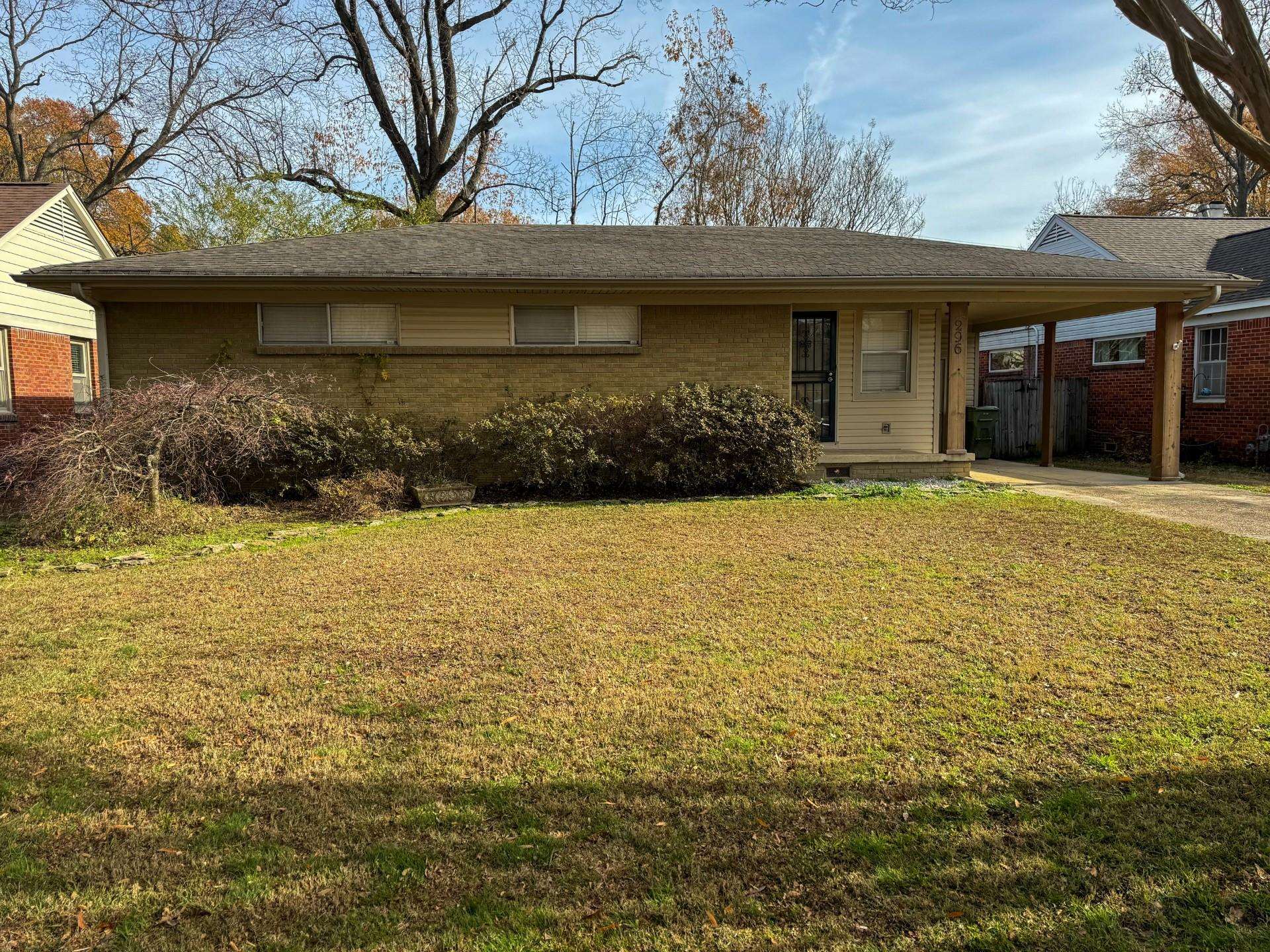 a view of house with yard and outdoor seating