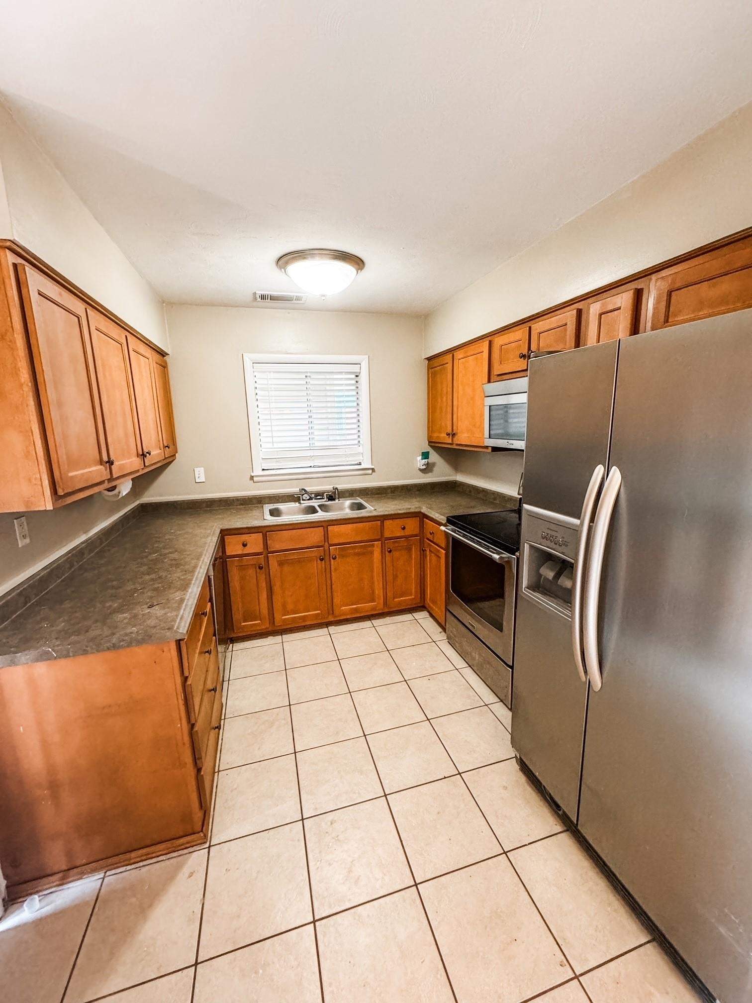 296 North Yates Road Memphis, TN 38120 - Photo 2 of 7 a kitchen with stainless steel appliances granite countertop a refrigerator sink and cabinets