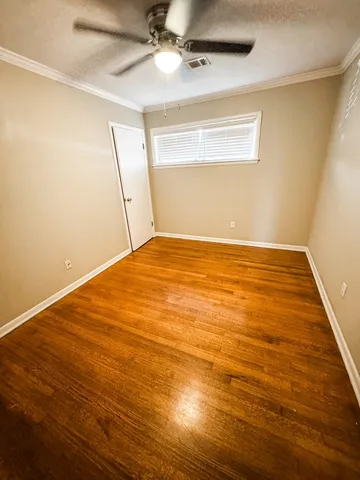 an empty room with wooden floor