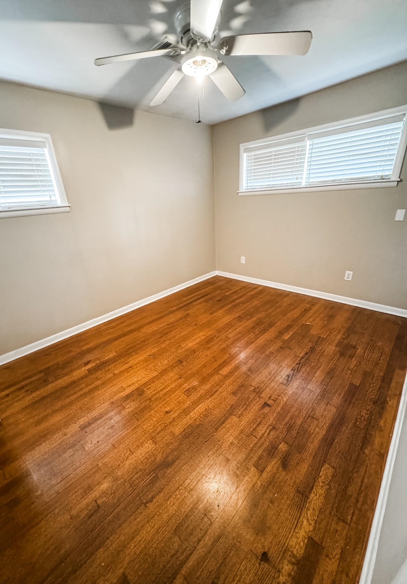 296 North Yates Road Memphis, TN 38120 - Photo 6 of 7 a view of an empty room with wooden floor and a window