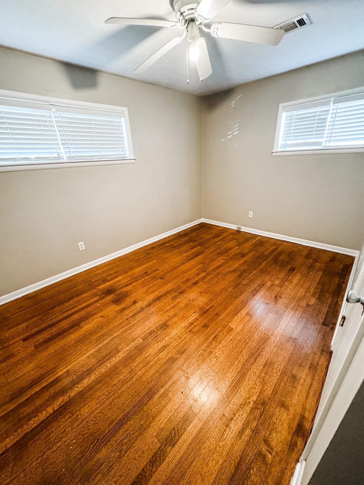 296 North Yates Road Memphis, TN 38120 - Photo 7 of 7 a view of an empty room with wooden floor and a window