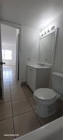 a view of a room with a sink and cabinets