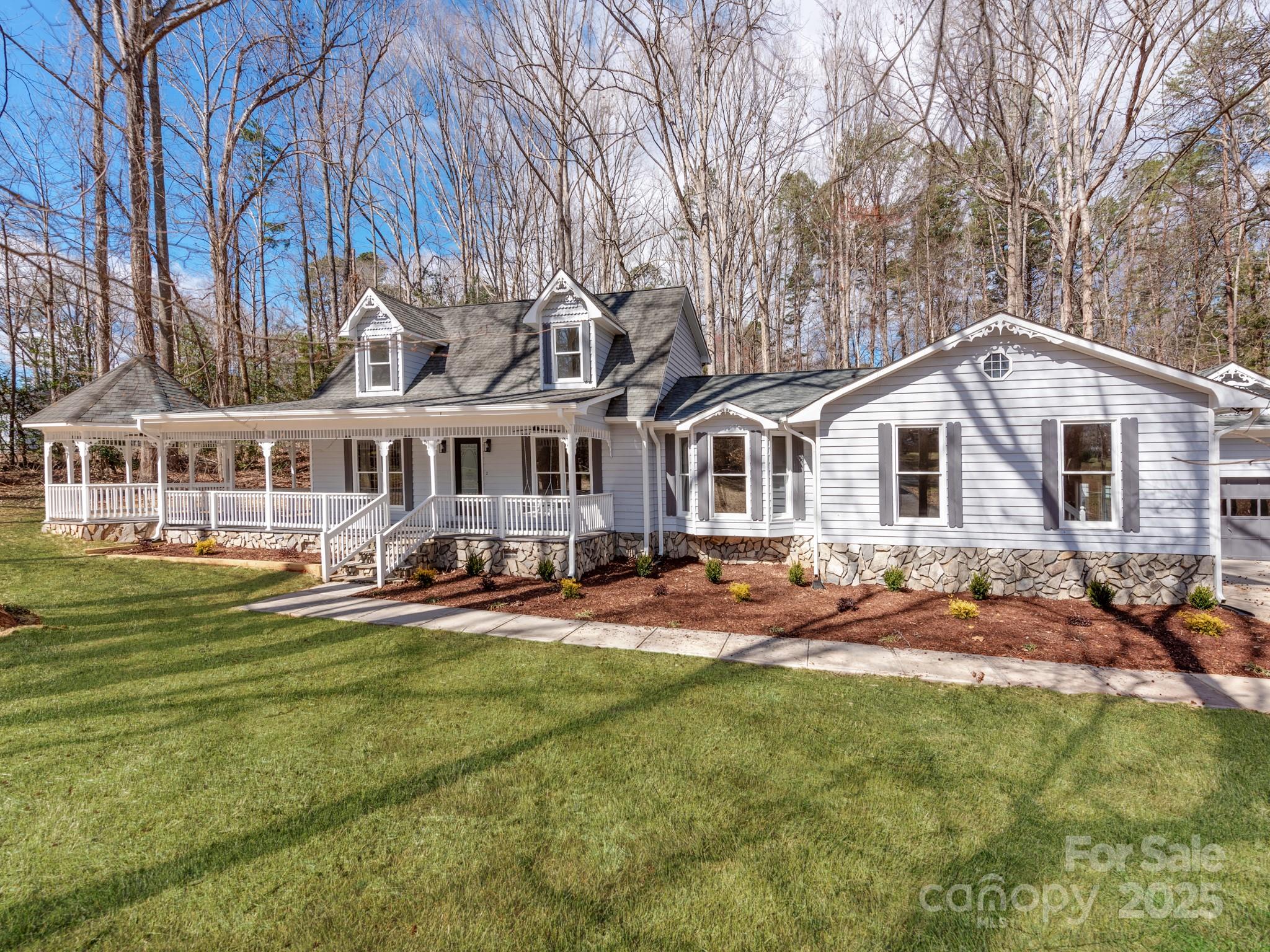 a view of a house with a yard patio and fire pit