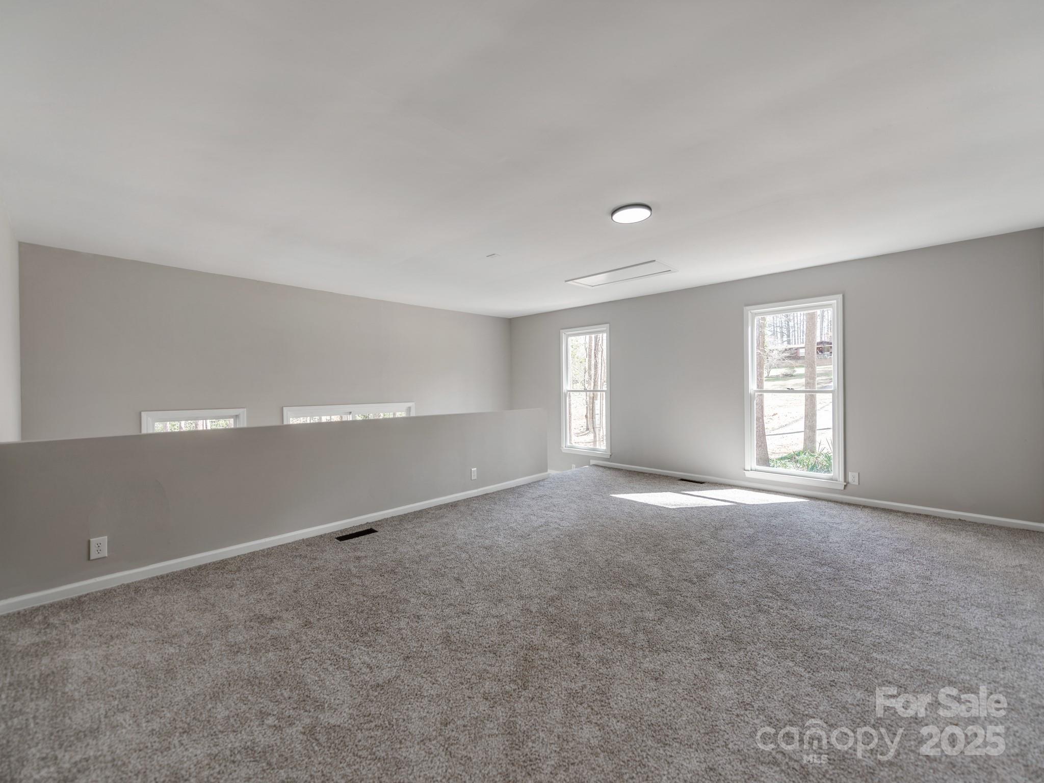 107 Rutledge Road Mount Holly, NC 28120 - Photo 11 of 26 a view of a big room with windows and chandelier fan