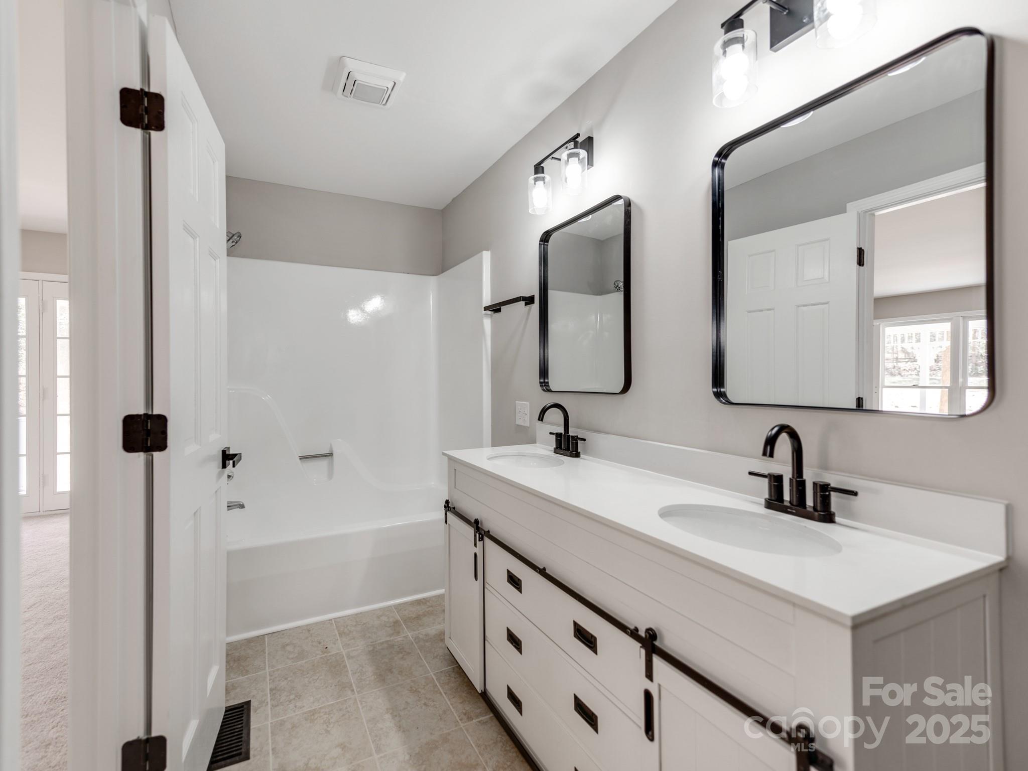107 Rutledge Road Mount Holly, NC 28120 - Photo 16 of 26 a bathroom with a double vanity sink mirror and double