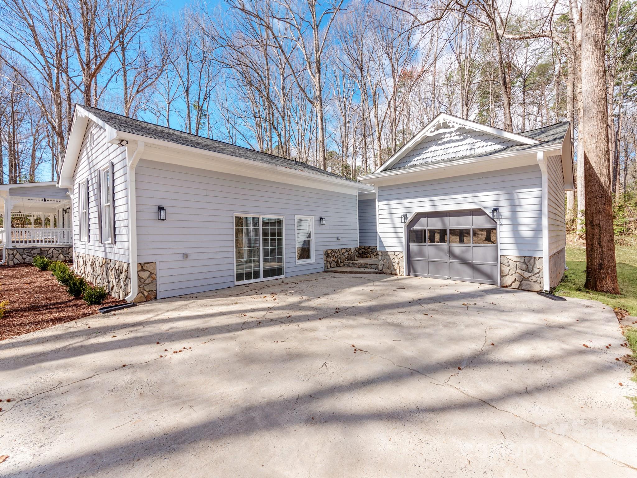 107 Rutledge Road Mount Holly, NC 28120 - Photo 23 of 26 a view of a house with a patio and a yard