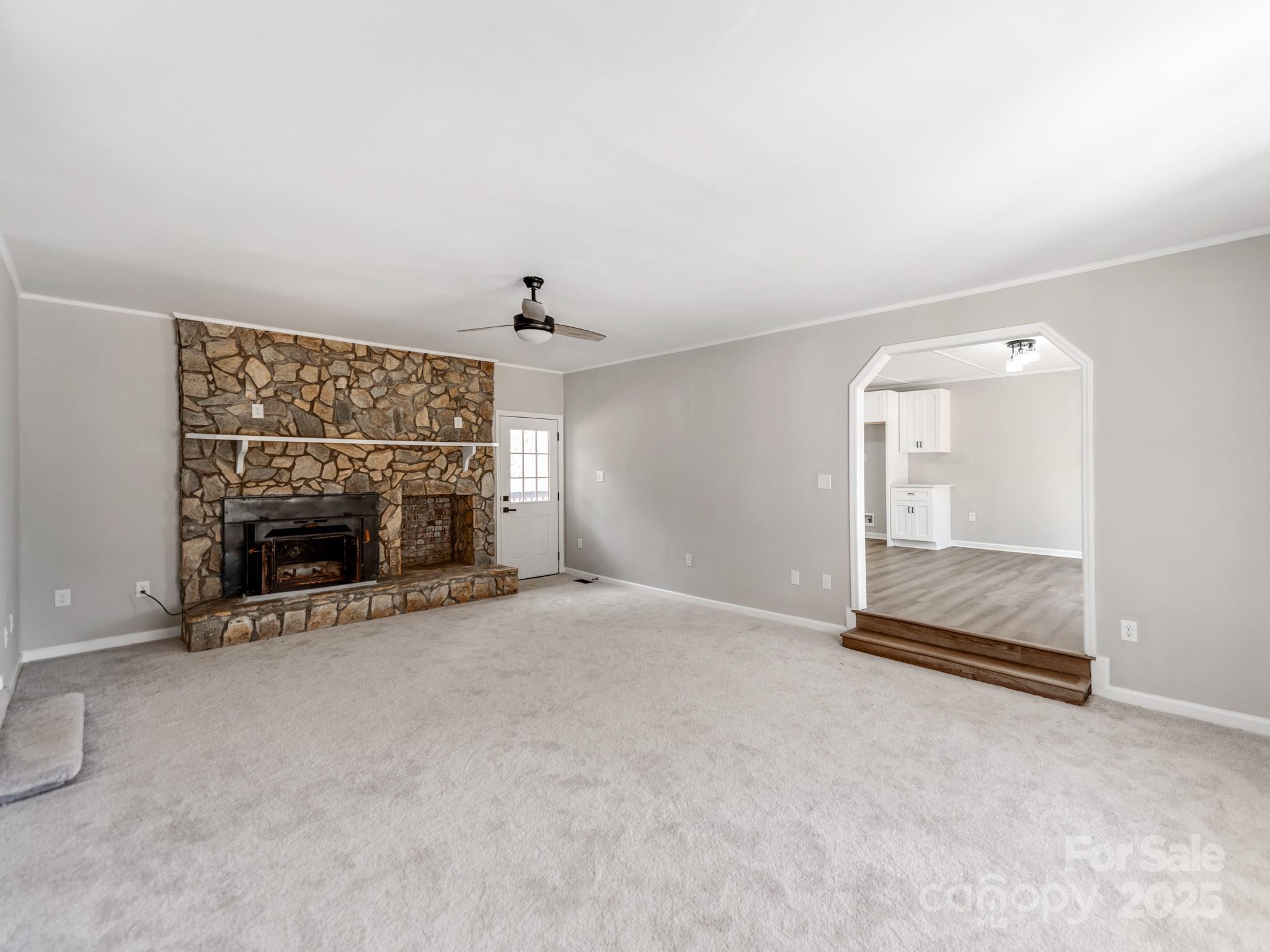 107 Rutledge Road Mount Holly, NC 28120 - Photo 5 of 26 an empty room with a fireplace and window