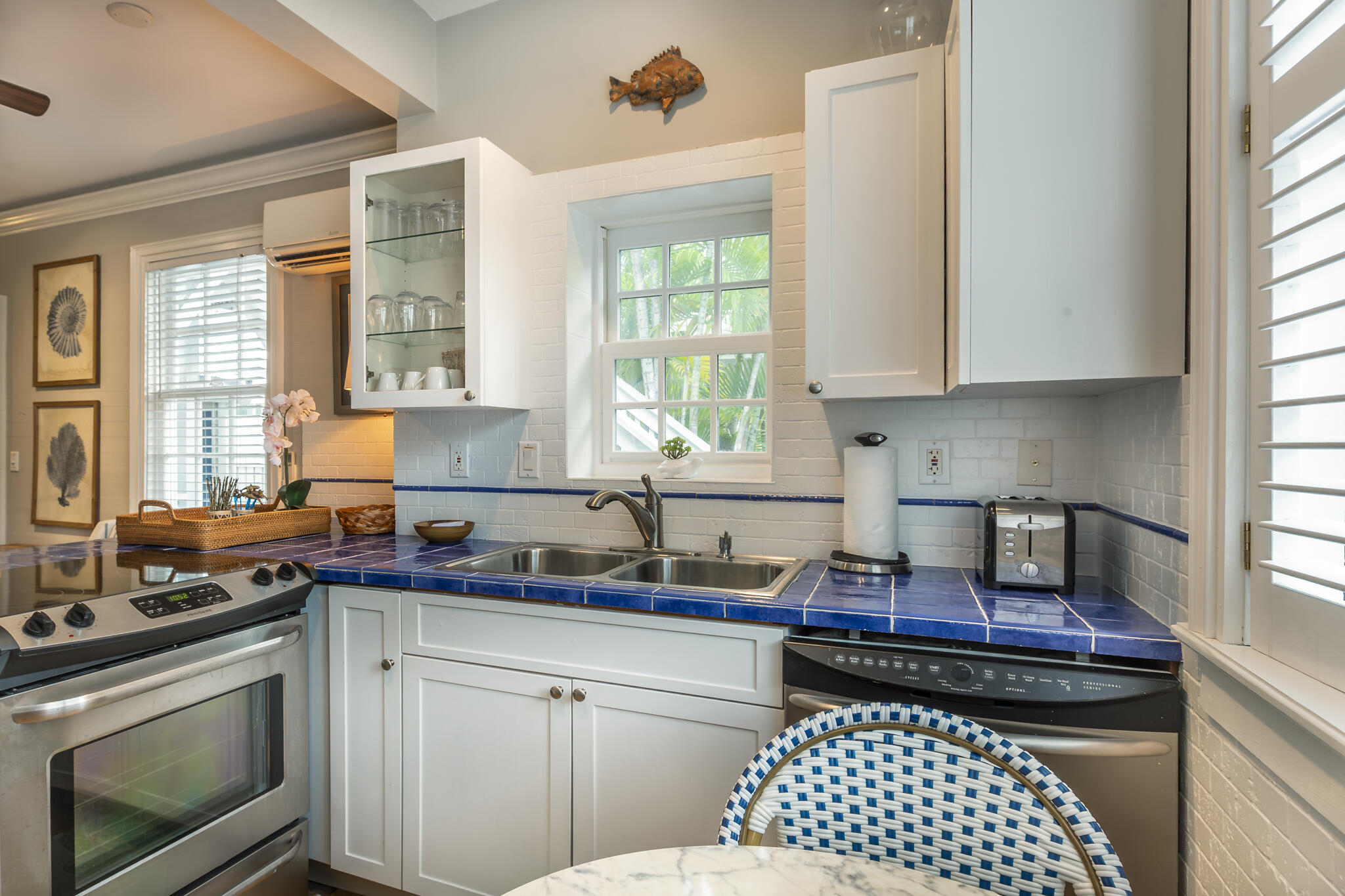 815 Pearl Street, Unit 2 Key West, FL 33040 - Photo 15 of 27 a kitchen with a stove a sink and a window