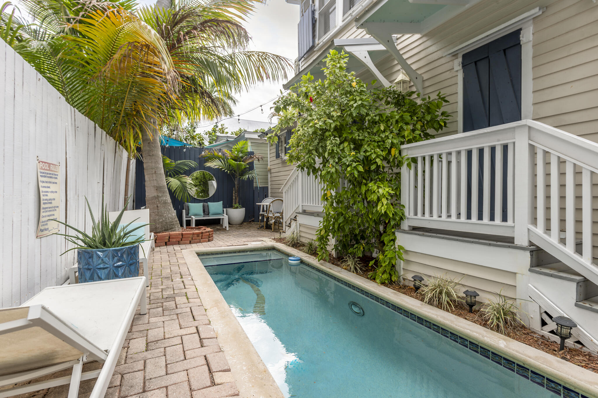 815 Pearl Street, Unit 2 Key West, FL 33040 - Photo 4 of 27 a view of swimming pool with potted plants and palm trees