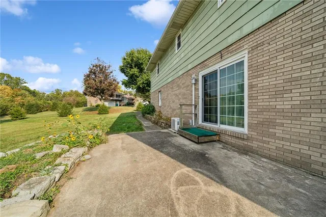 a view of a white house with a yard