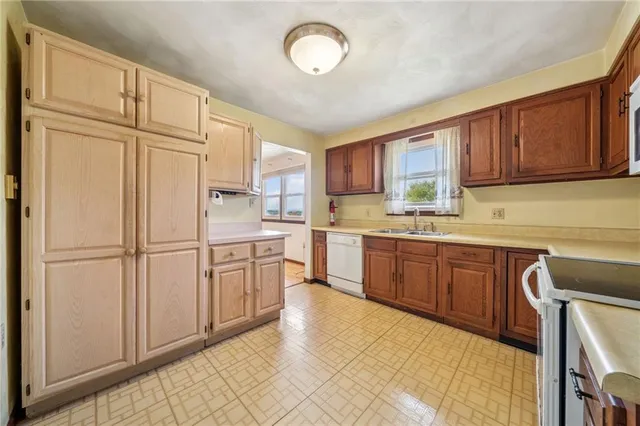 a kitchen with stainless steel appliances granite countertop a refrigerator sink and cabinets