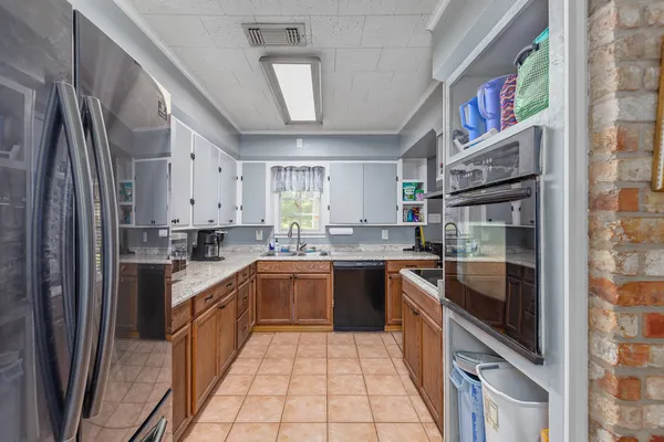 a kitchen with stainless steel appliances granite countertop a stove a sink and a refrigerator