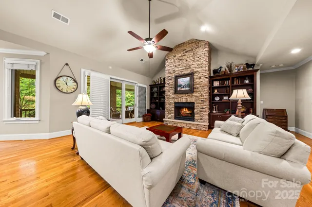 a living room with fireplace furniture and a large window