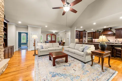 a living room with furniture and kitchen view