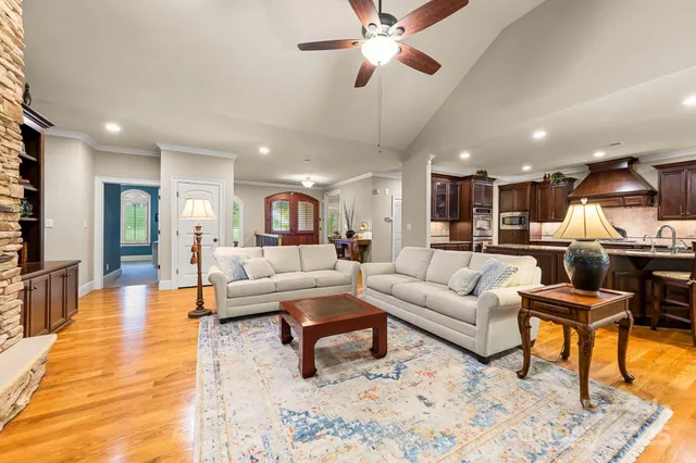 a living room with furniture and kitchen view