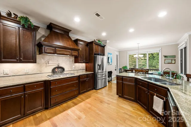 a kitchen with wooden cabinets and stainless steel appliances