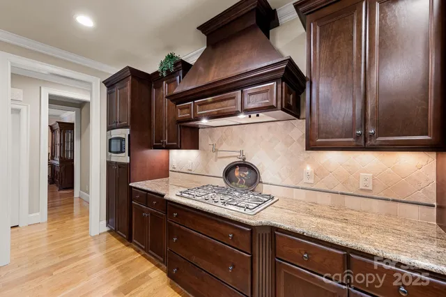 a kitchen with granite countertop a sink stove and cabinets