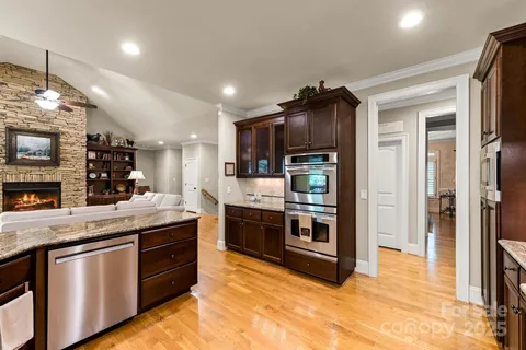 a kitchen with stainless steel appliances granite countertop a stove and a refrigerator