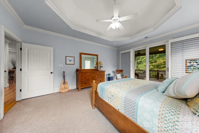 a spacious bedroom with a bed a window and a chandelier
