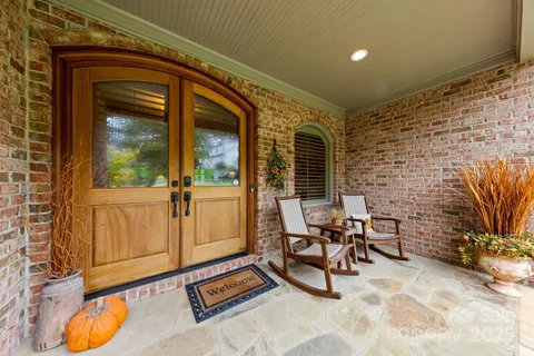 a view of balcony with chairs and tables
