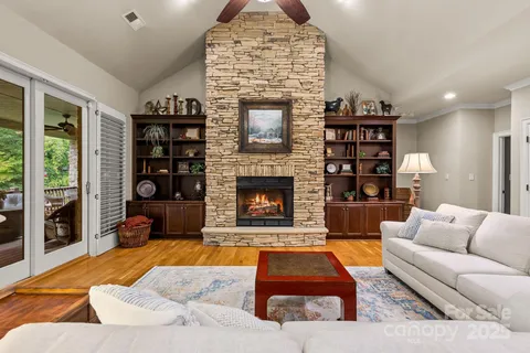 a living room with furniture a rug and a fireplace