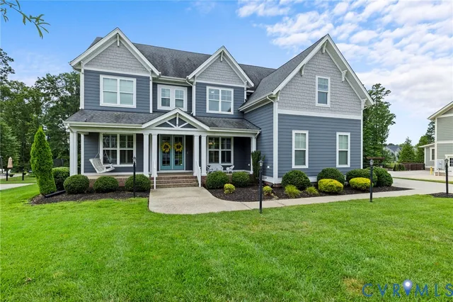 a front view of a house with garden and porch