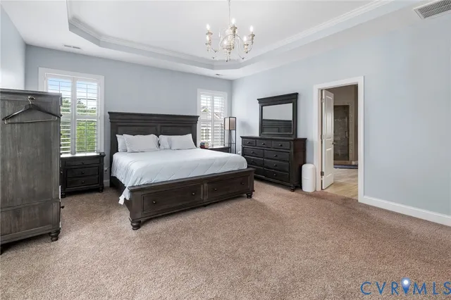 a bedroom with a bed and a chandelier