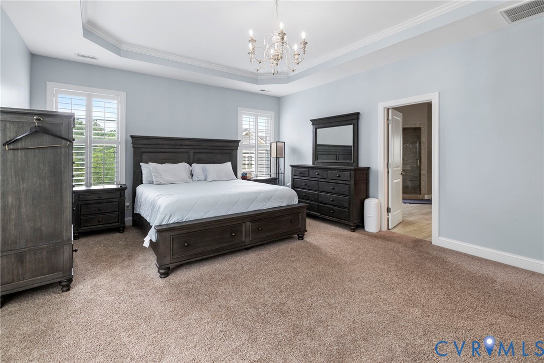 16507 Hannington Drive Midlothian, VA 23112 - Photo 22 of 43 a bedroom with a bed and a chandelier