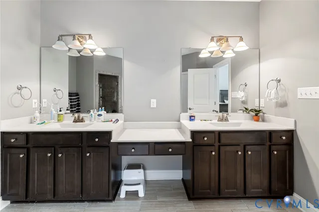a bathroom with a double vanity sink and a mirror
