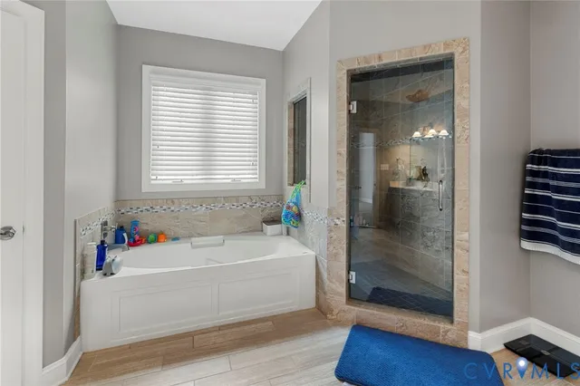 a bathroom with a bathtub and a shower