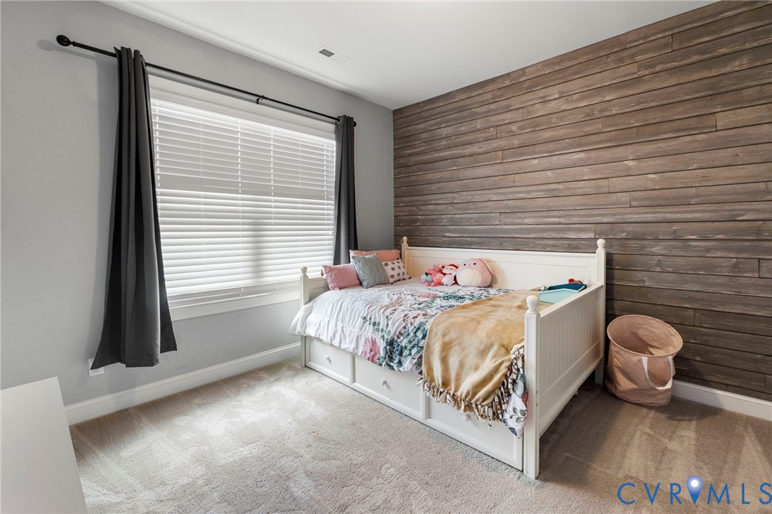 16507 Hannington Drive Midlothian, VA 23112 - Photo 31 of 43 a bed sitting in a bedroom next to a window