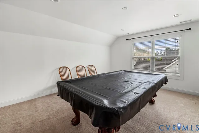 a kitchen with a table chairs and a refrigerator