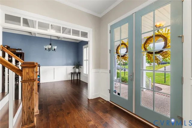 a view of entryway and hall with wooden floor
