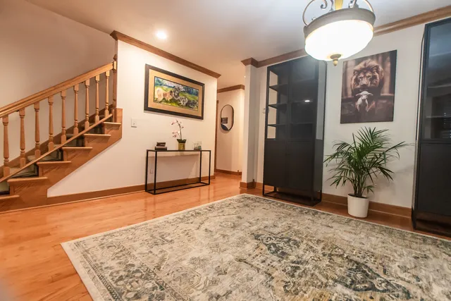 a view of a bedroom with wooden floor