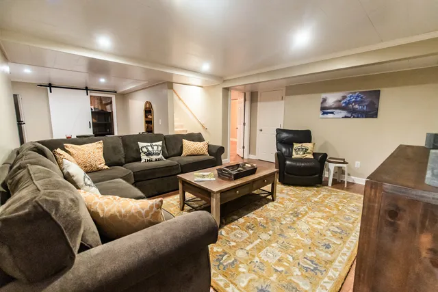 a spacious bedroom with a bed and a flat screen tv