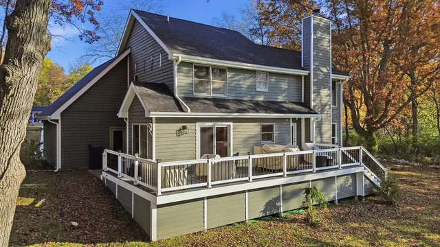 a view of balcony with deck and wooden stairs